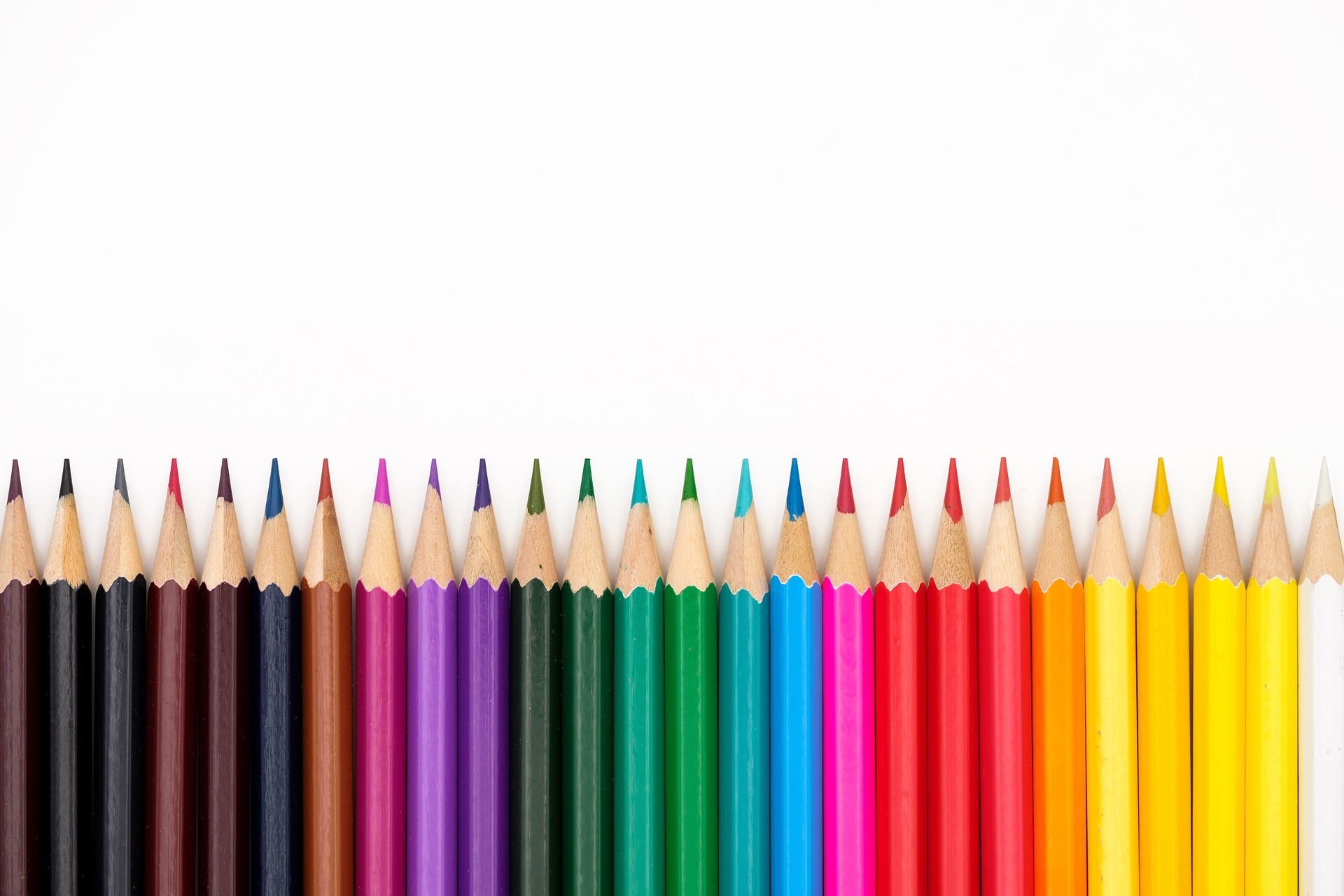 A row of colored pencils lined up in a line.