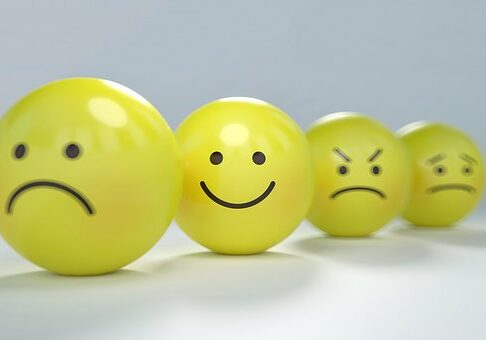 A row of yellow balls with faces drawn on them.