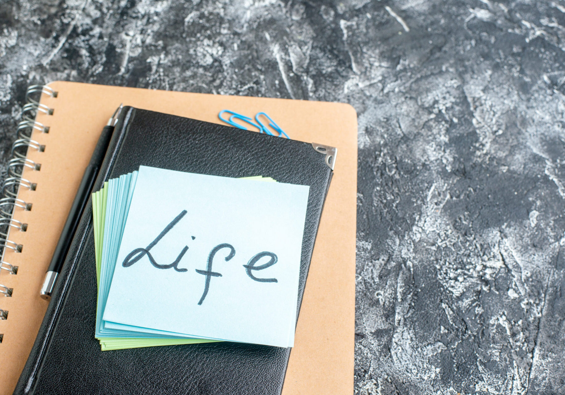 A stack of paper with the word life written on it.